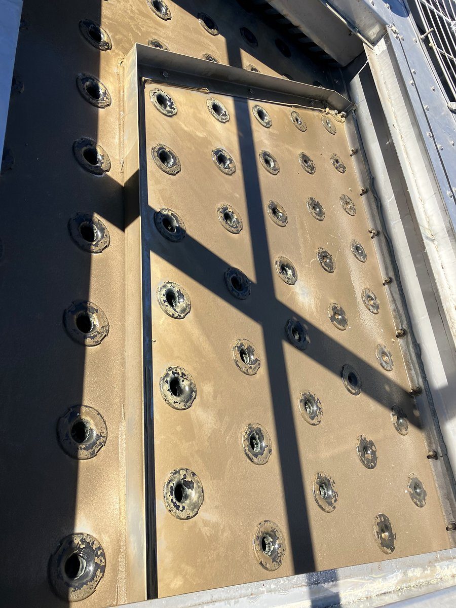 Cooling tower distribution basin clogged with sludge and debris