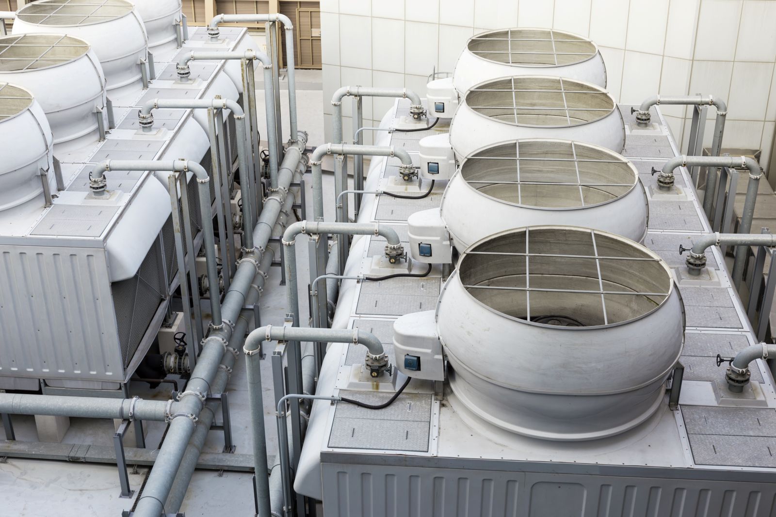 Commercial cooling tower array protected by treatment chemistry