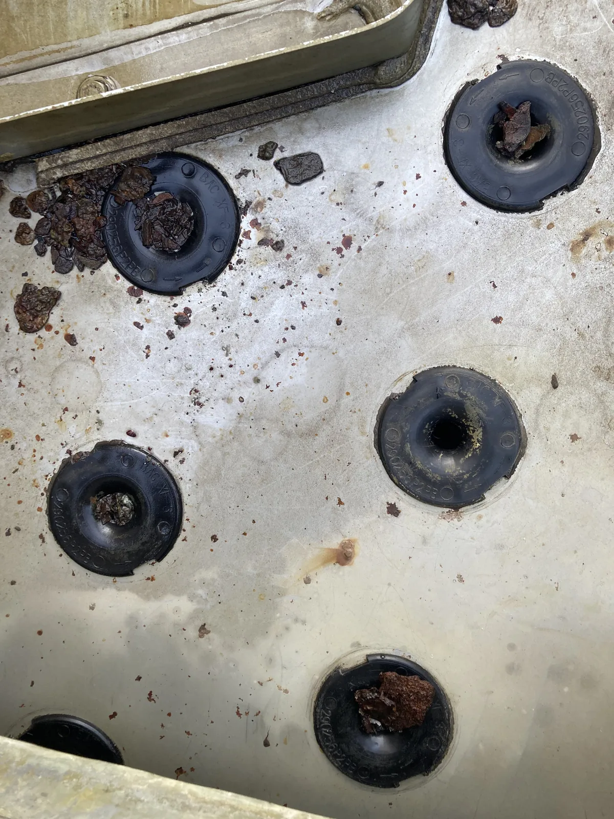 Close-up of cooling tower nozzles plugged with brown debris